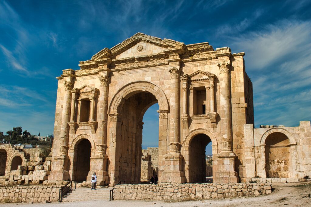 The ancient Arch of Hadrian stands tall in Jerash, a significant Roman archaeological site in Jordan.